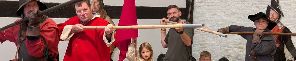 A banner with adults and children pretending to be in the cavalry